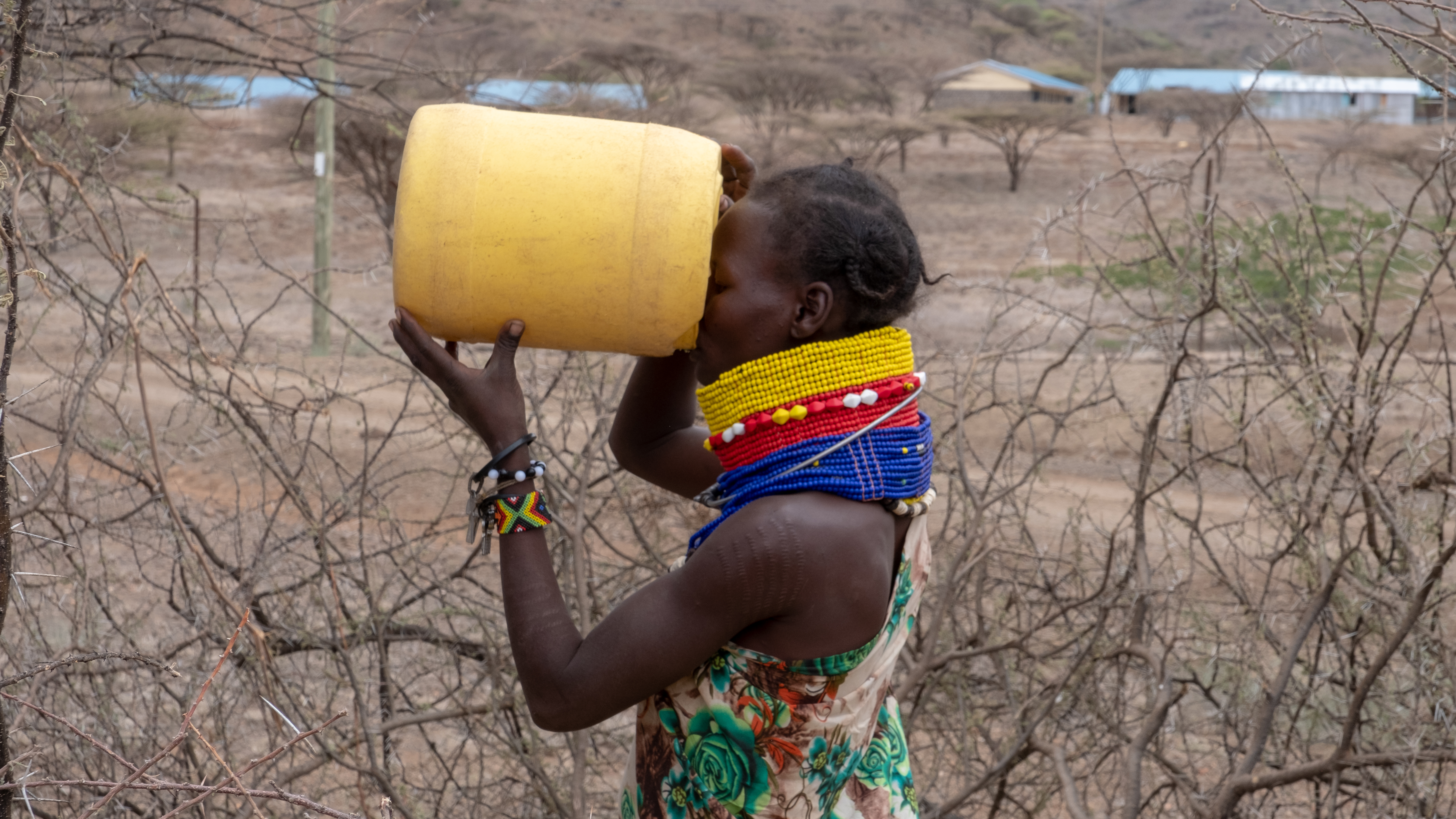 DSCF7081 Lady quenching her thirst straight from her jerrican at the watering hole