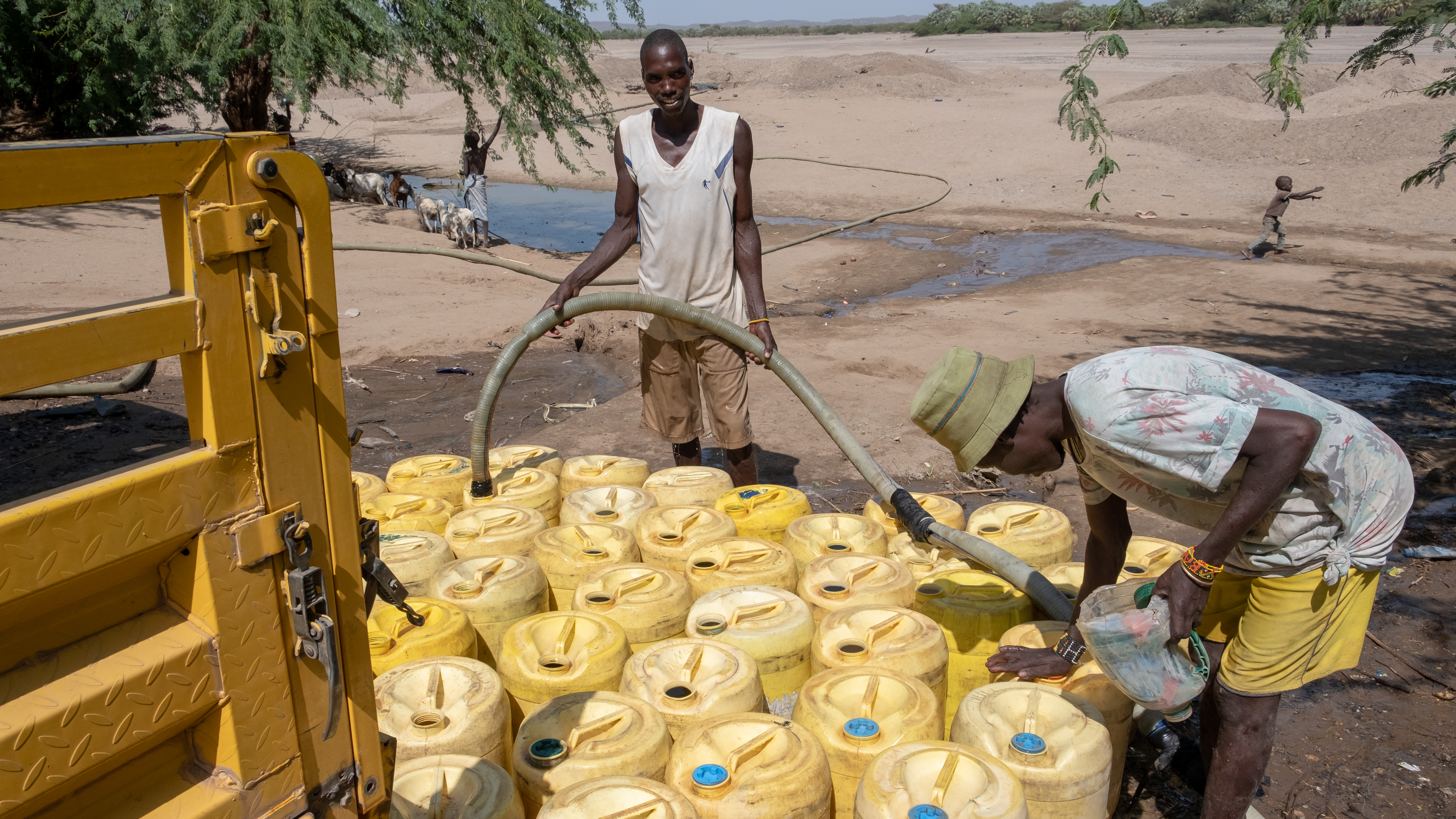 DSCF8532 Water vendors filling up thier jericans with water from the shallow well 10
